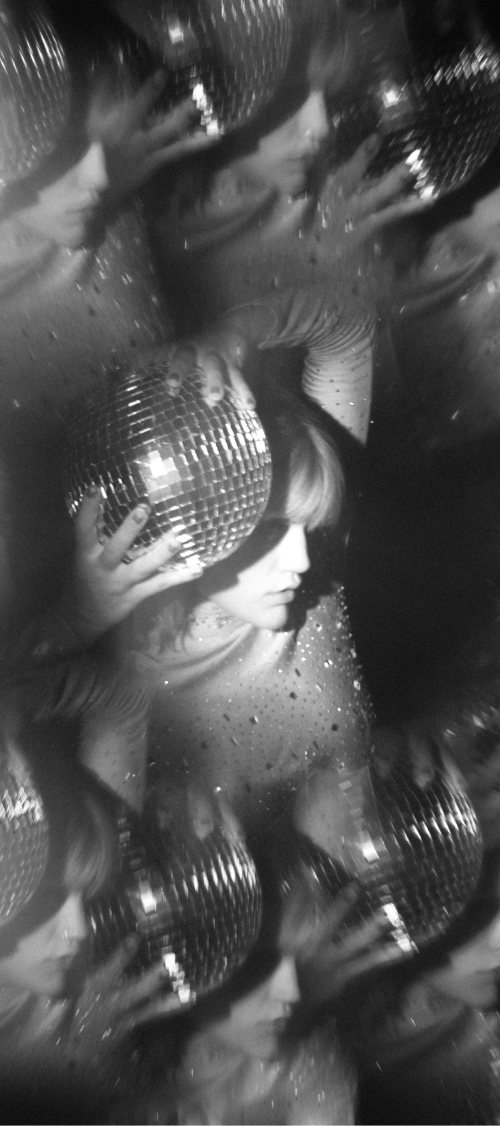 A person holding a disco ball is repeated in a blurred image in grayscale. Displays as a backgroud with the logo for the event on it.