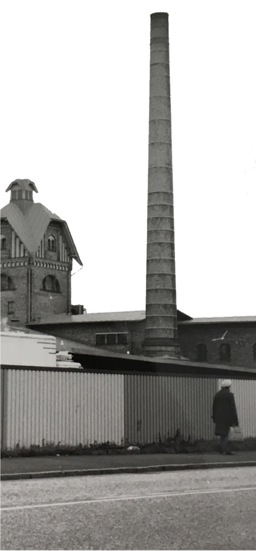 A grayscale image of a house with a chimney where animated smoke comes from